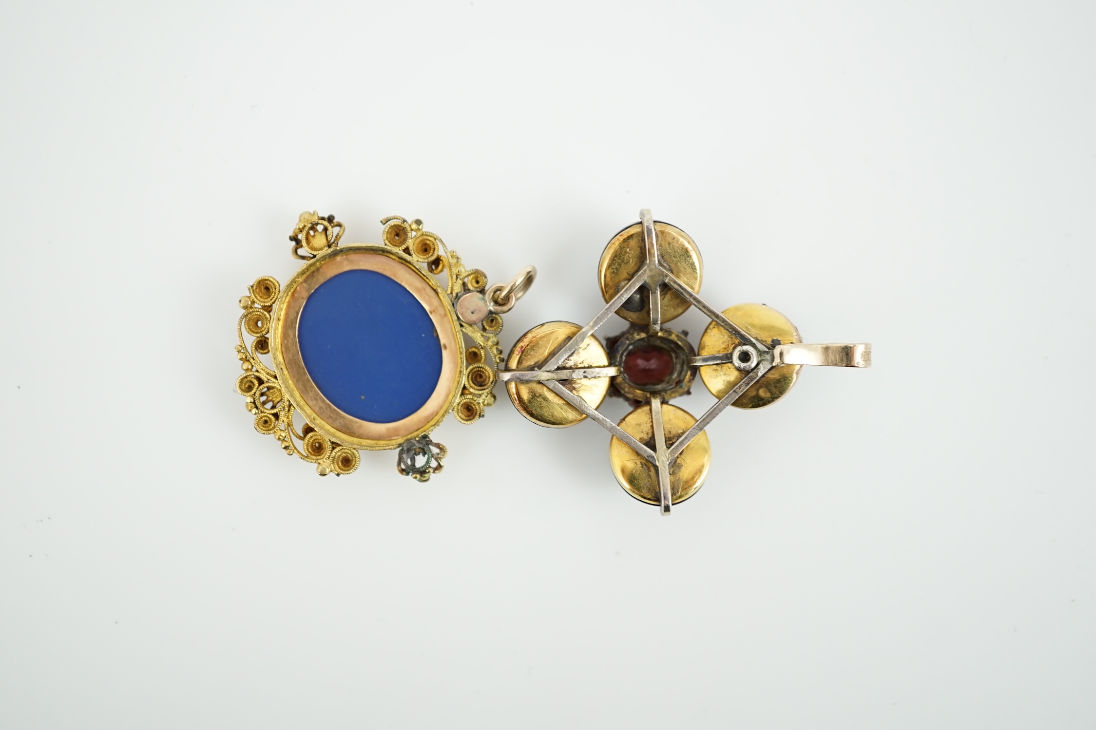 A 19th century gilt metal mounted micro mosaic pendant, 32mm, together with a similar cabochon garnet and diamond set quatrefoil pendant.